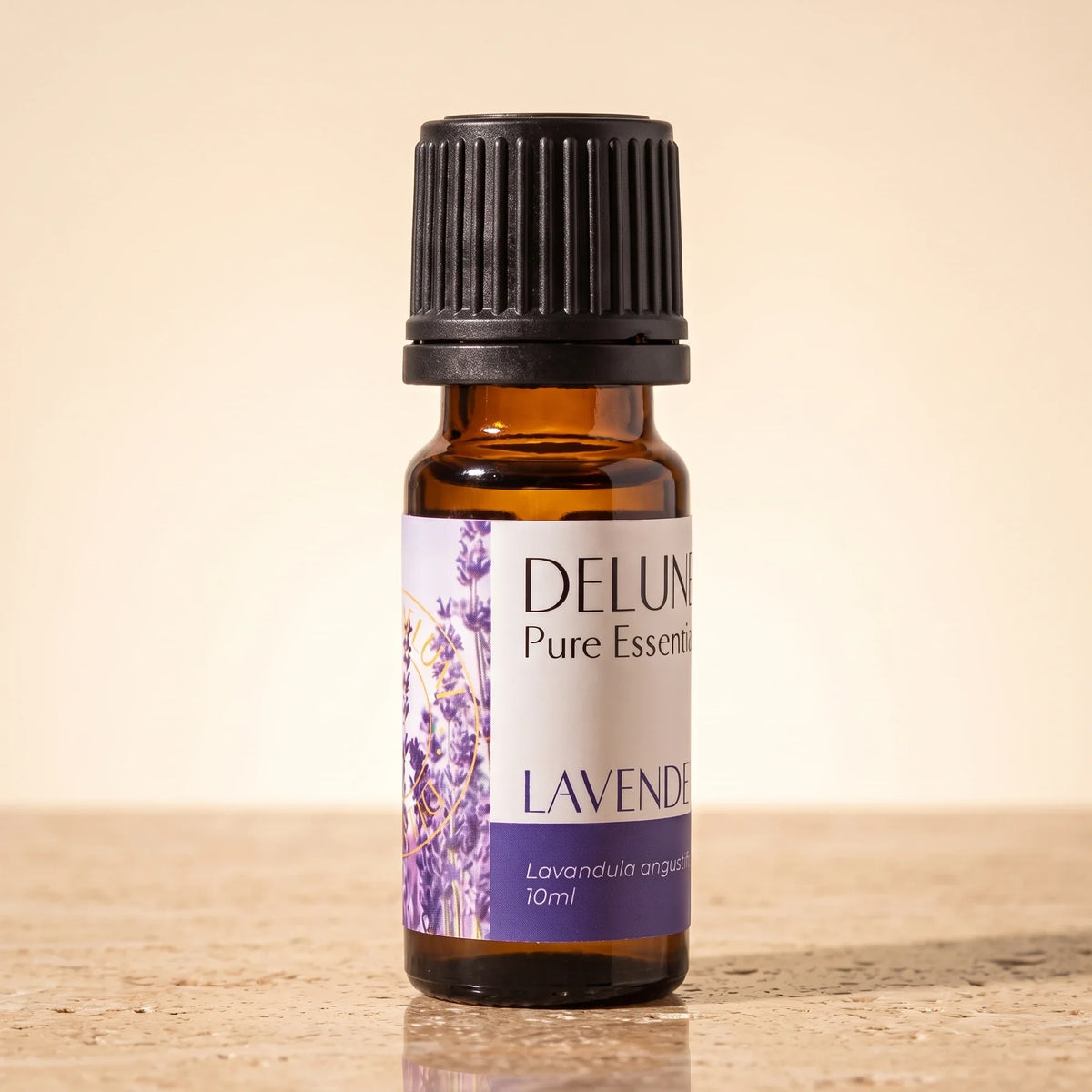 Delune Lavender (French) Pure Essential Oil, 10ml amber glass bottle on warm travertine stone