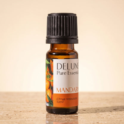 Delune Mandarin Pure Essential Oil, 10ml amber glass bottle on warm travertine stone