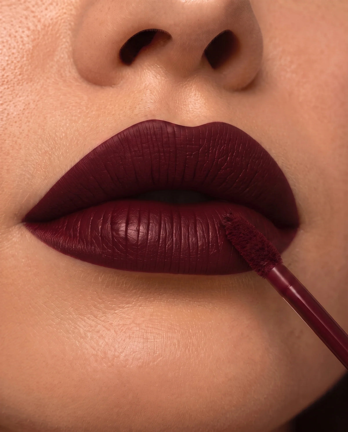 LuxMatte 24-Hour Lipstick in Cabernet Kiss on lips
