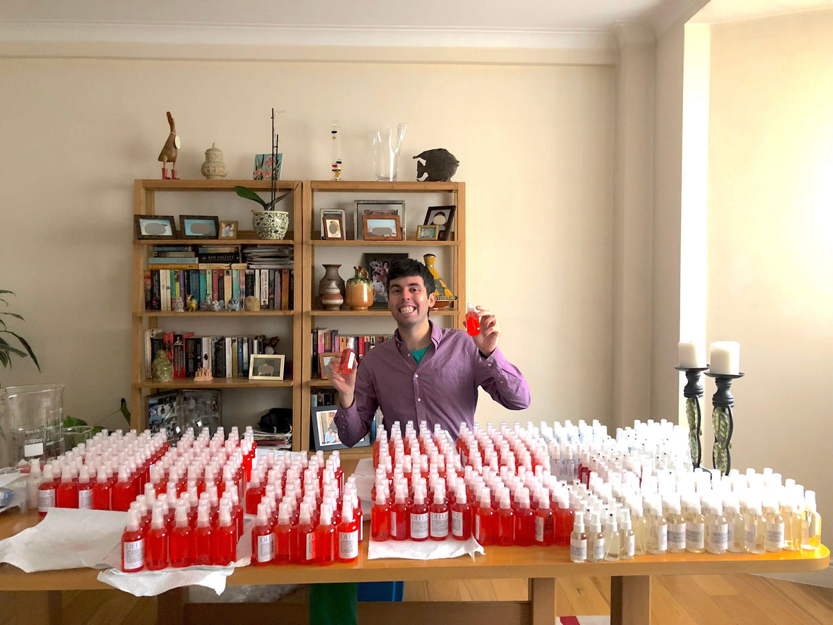 Delune's founder in 2018 behind tables covered with the first big order of bottles